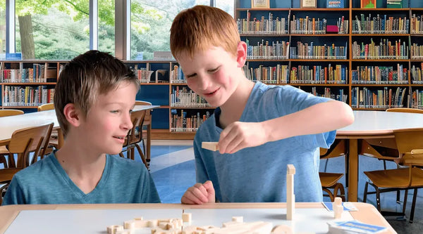 Boys playing creativity and communication game, Asymbol in school library