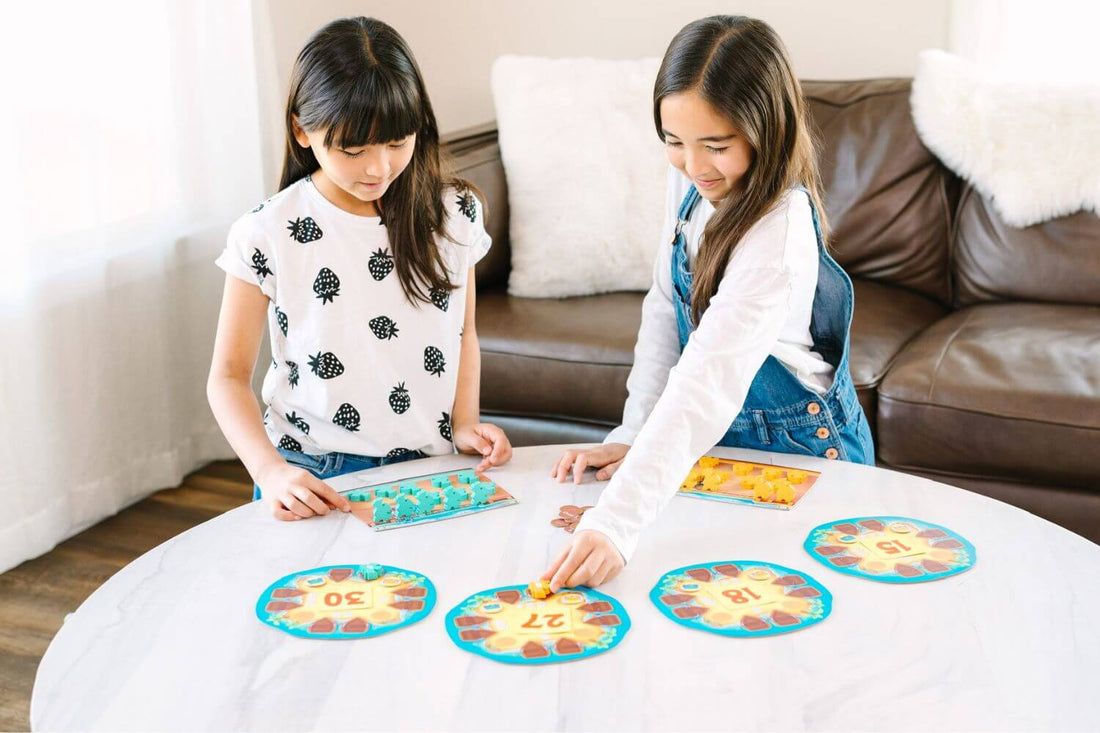 Girls playing a cool math game with a pirate theme, Plundering Times.