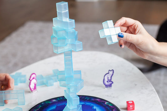 Friends playing a stacking game on game night