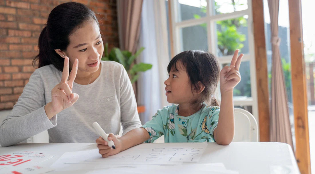 Mother and daughter working on math problems together.
