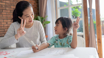 Mother and daughter working on math problems together.