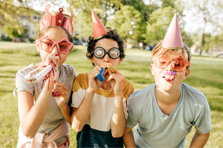 Kids having fun outside with birthday party favors.