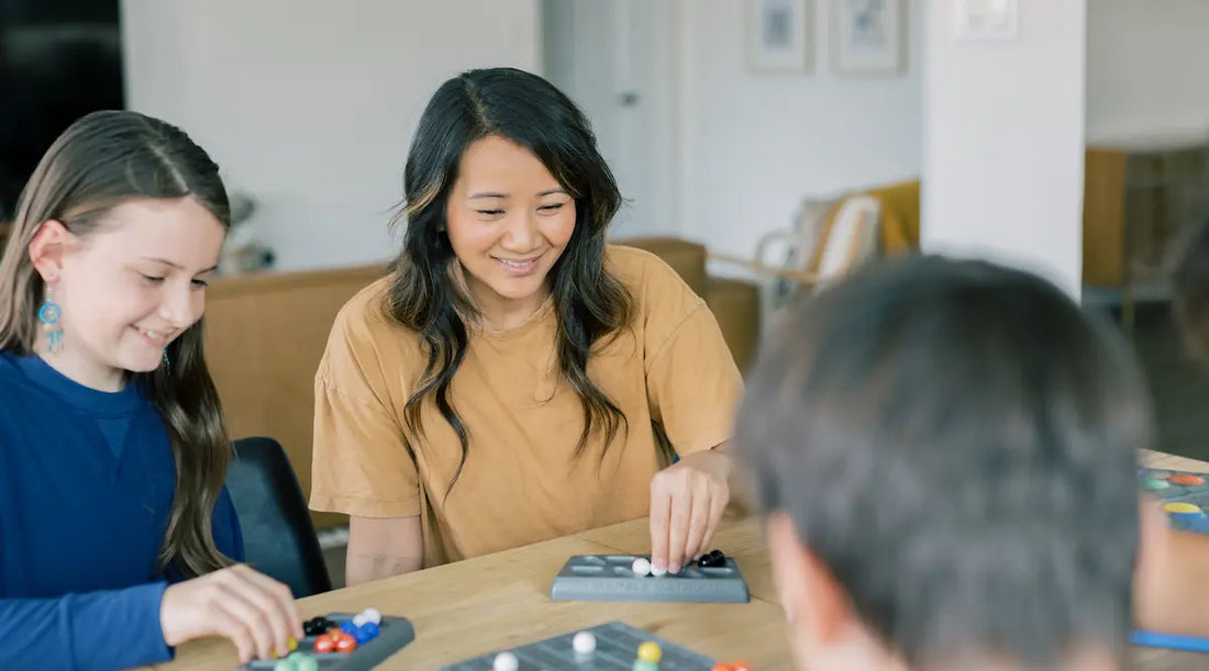 mom and family playing a board game called Marble Matrix.