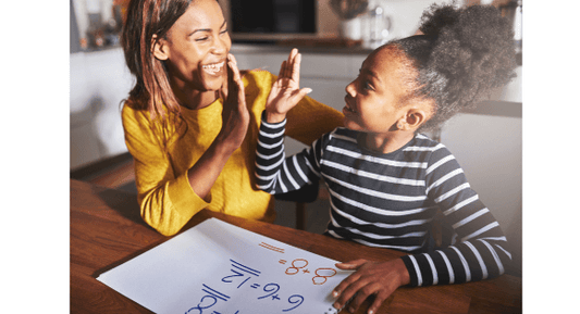 Mom and daughter high-five while learning math concepts