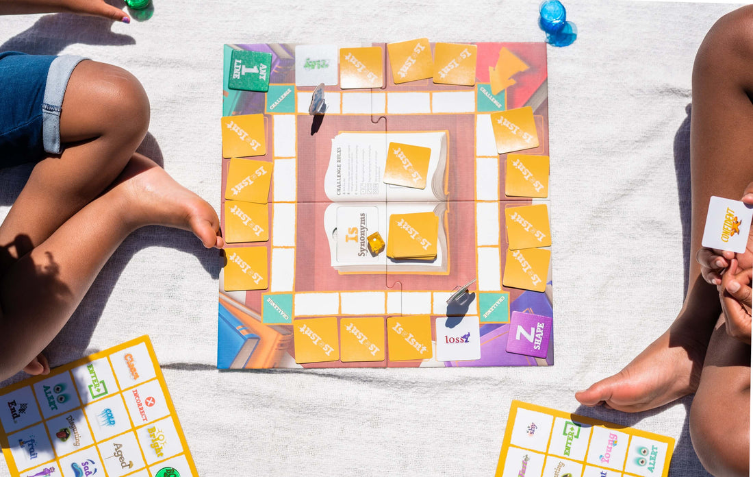 Two children play SimplyFun's language game, Is or Isn't, outdoors in the sunshine.