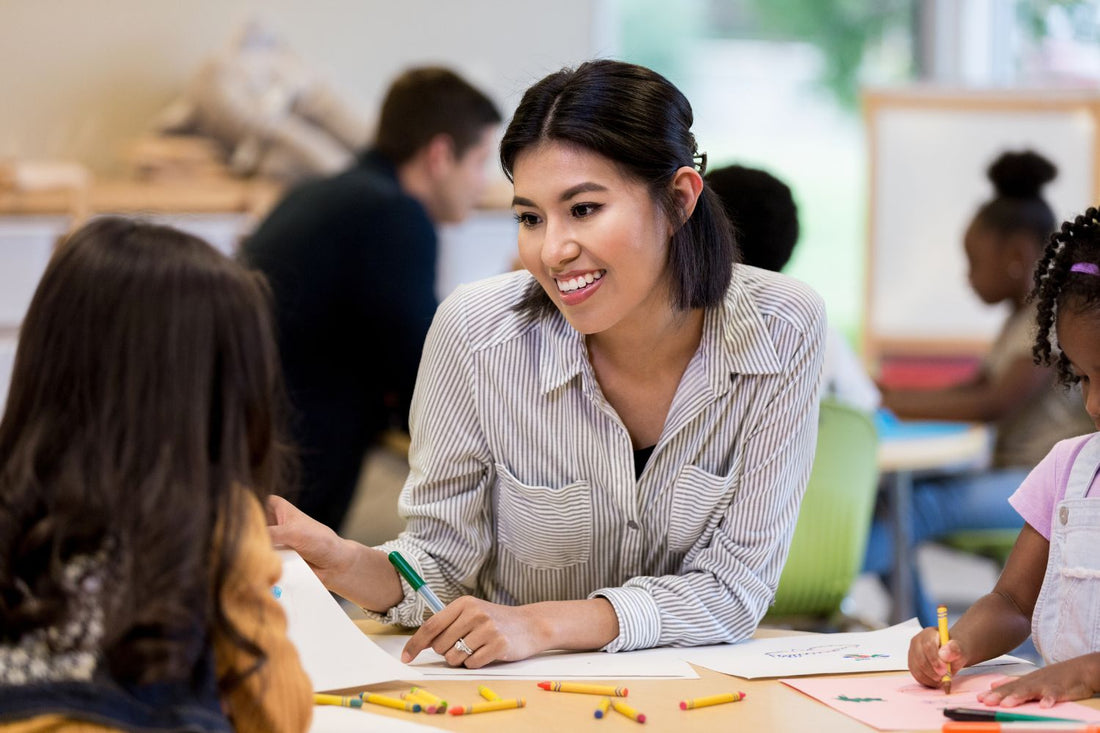 Developmentally Appropriate Practice being used in the classroom. Teacher providing DAP to preschoooler.
