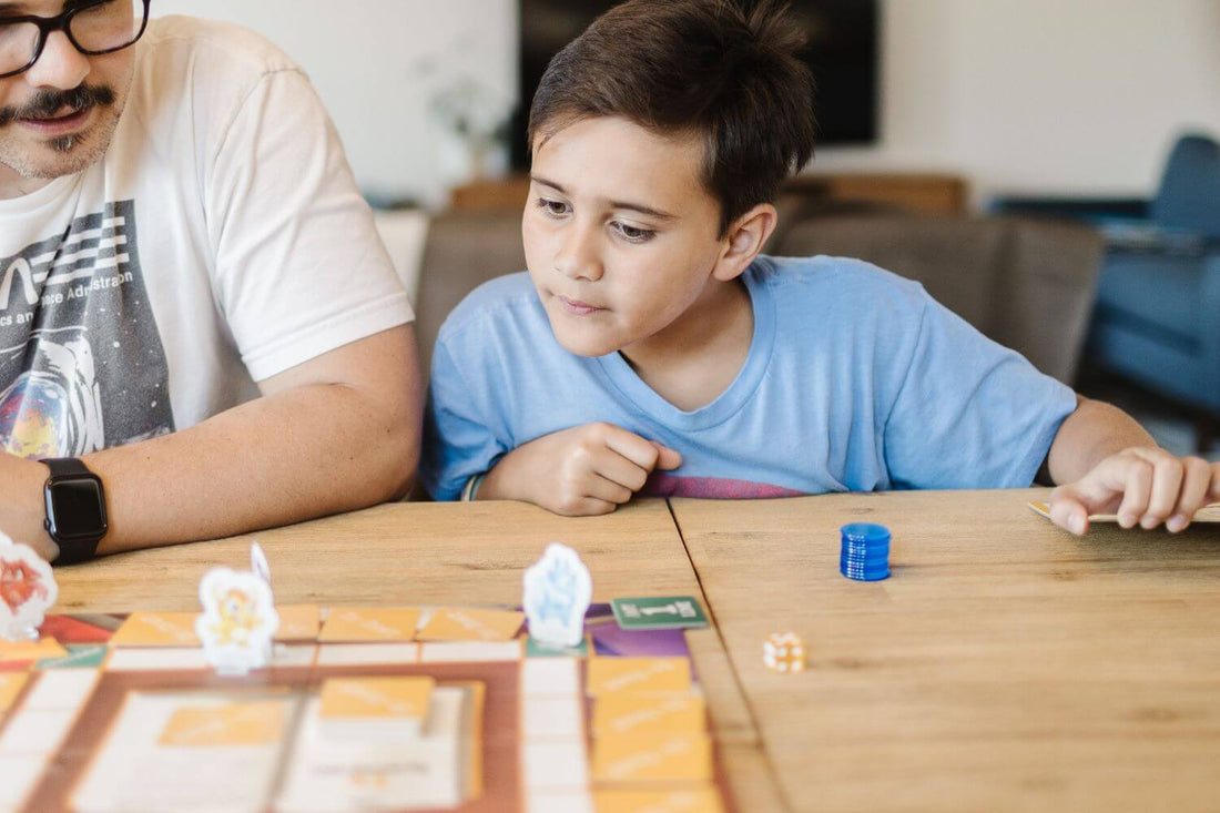 Father and son playing a writing game for kids. Featuring Is or Isn't thesaurus game