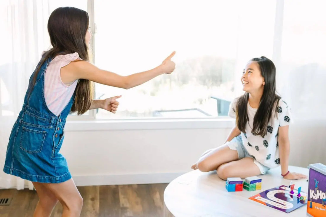 Funny board games - two sisters playing charades and drawing game Kahootz!