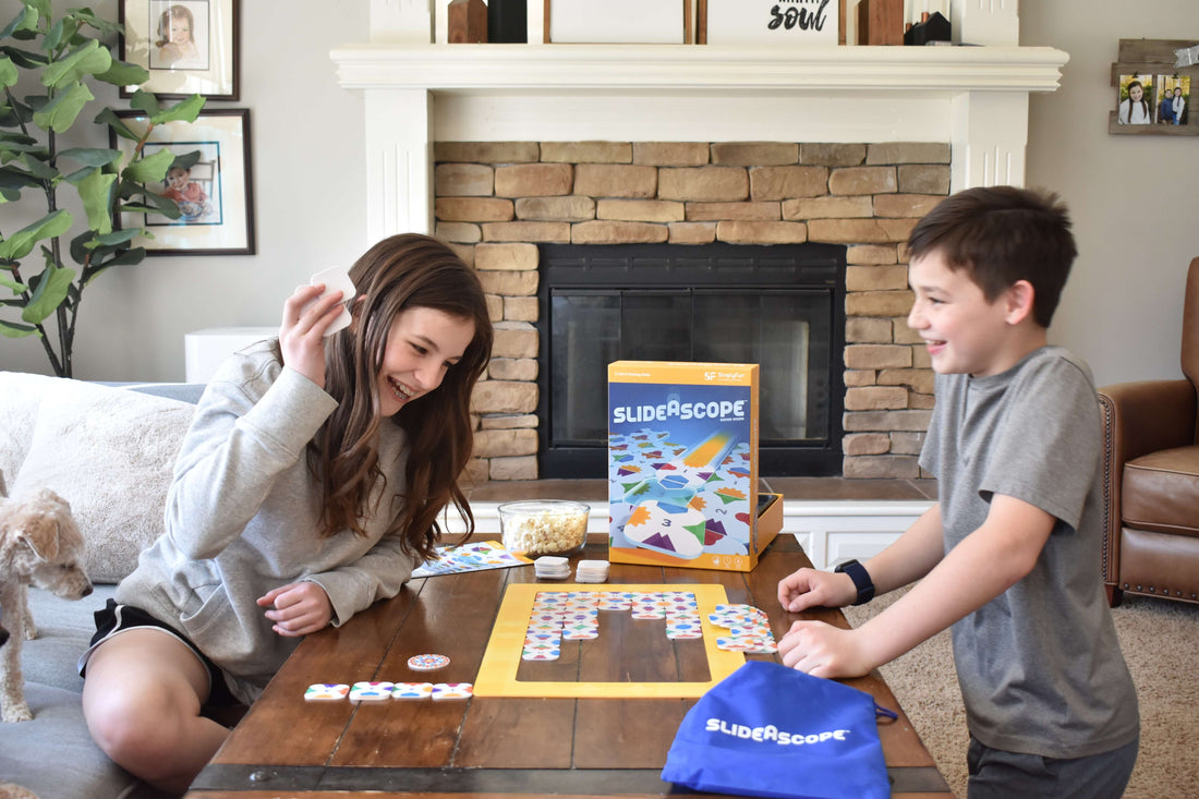 Young girl and boy playing SimplyFun's spatial reasoning game, SlideAscope 