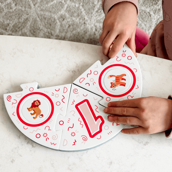 Dance Like a Lemur game from SimplyFun. Featuring a colorful box with playful lemur illustration and foam game puzzle pieces and die with a variety of animal and icon imagery. -SimplyFun