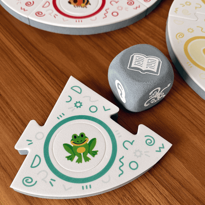 Dance Like a Lemur game from SimplyFun. Featuring a colorful box with playful lemur illustration and foam game puzzle pieces and die with a variety of animal and icon imagery. 