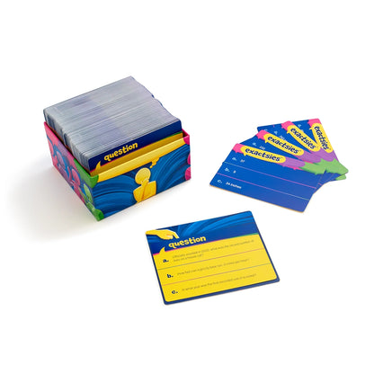 A boxed card game set with a stack of cards in a colorful box, a few cards fanned out, and one card placed in front on a white background.