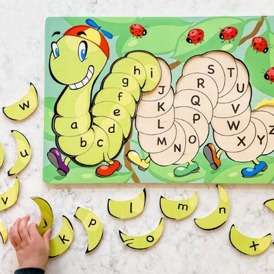 Tibbar's Little Hands, Big Smiles by SimplyFun is a set of three puzzles focusing on shapes, colors, lowercase and uppercase letters, and counting.