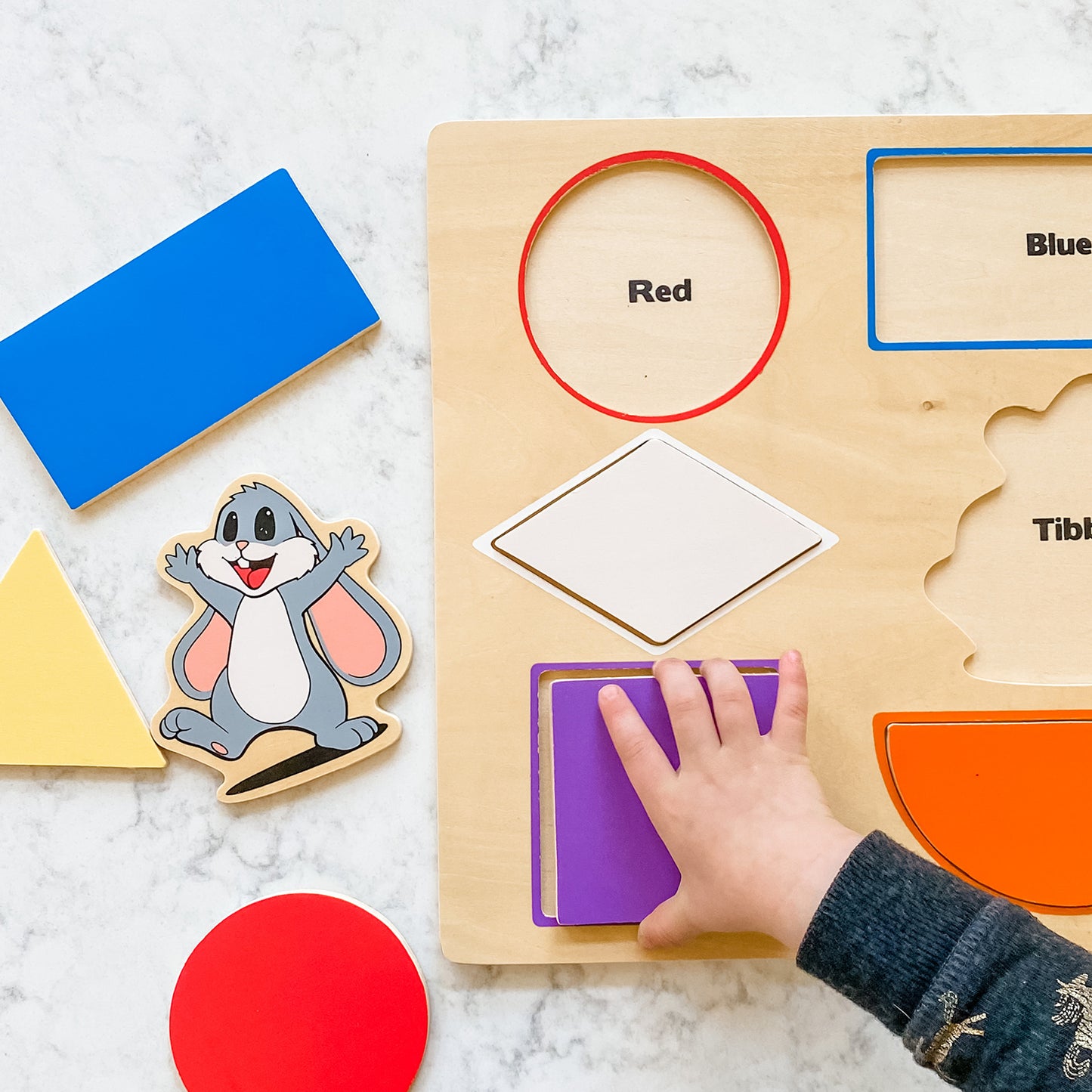 Tibbar's Little Hands, Big Smiles by SimplyFun is a set of three puzzles focusing on shapes, colors, lowercase and uppercase letters, and counting.