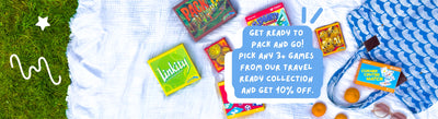 Collection of travel games on a white blanket