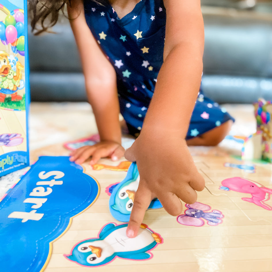 Pickles' Slide to Win by SimplyFun is an eye-hand coordinaion game which teaches taking turns for ages 4 and up.