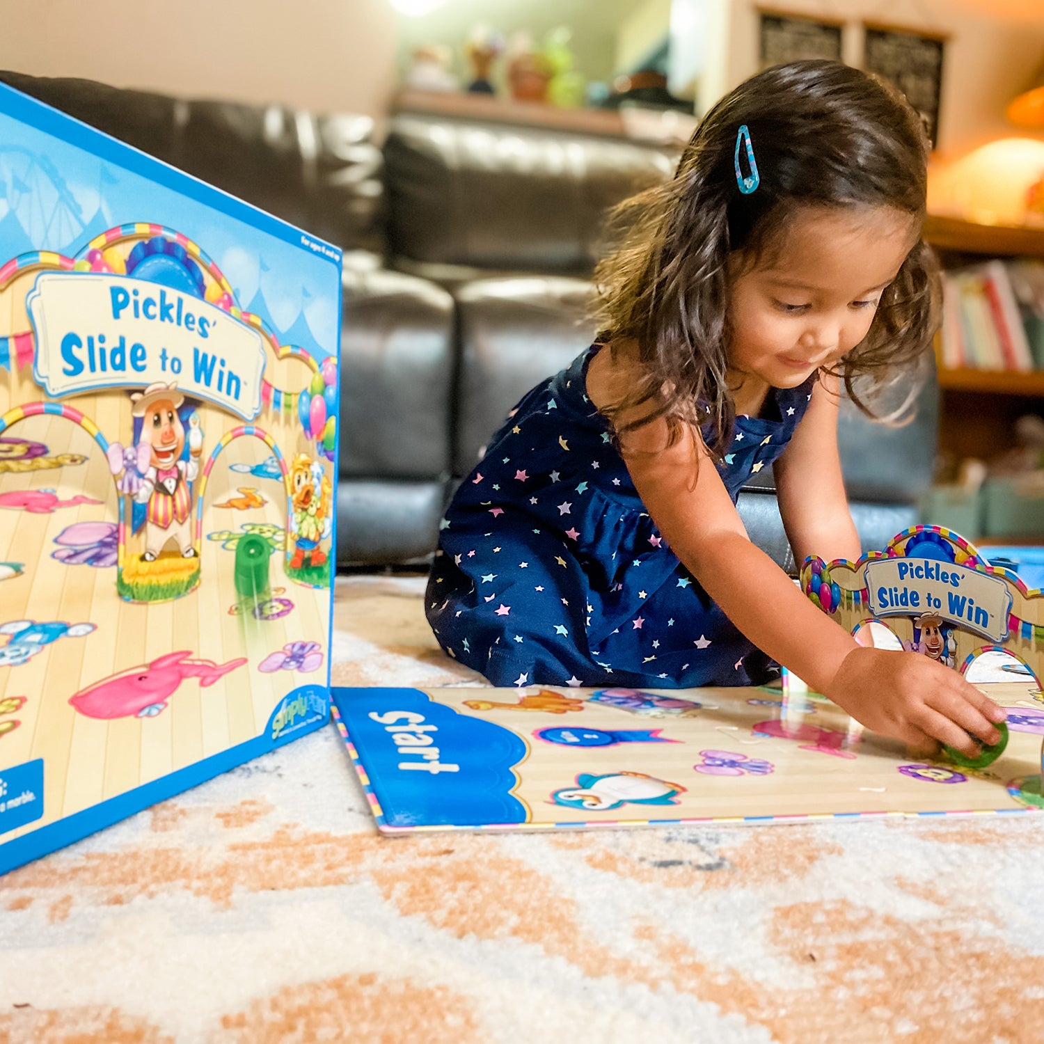 Pickles' Slide to Win by SimplyFun is an eye-hand coordinaion game which teaches taking turns for ages 4 and up.