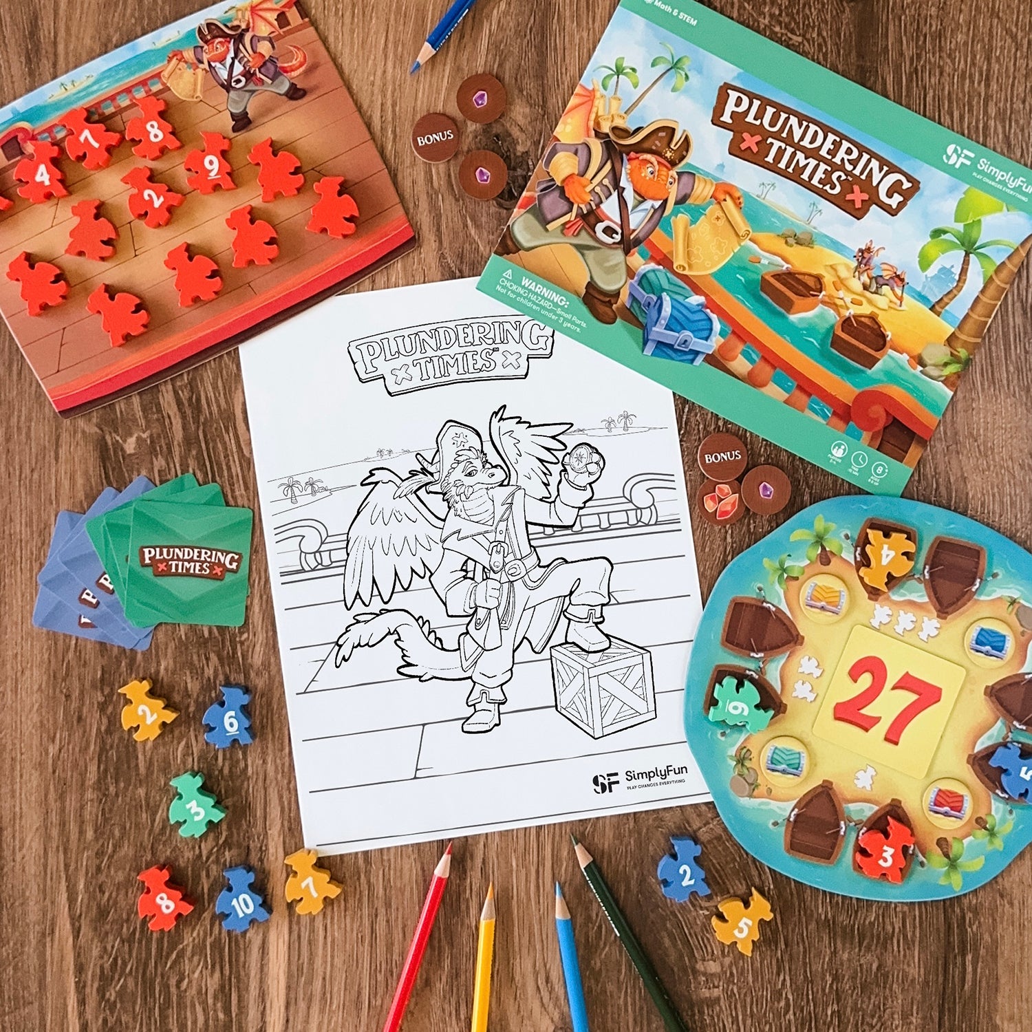 Dragon pirate coloring page from Plundering Times multiplication game by SimplyFun, surrounded by game pieces and colored pencils