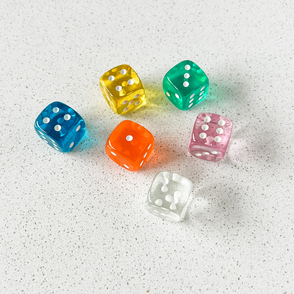 Six colorful dice in a travel box, with a dice game, by SimplyFun.