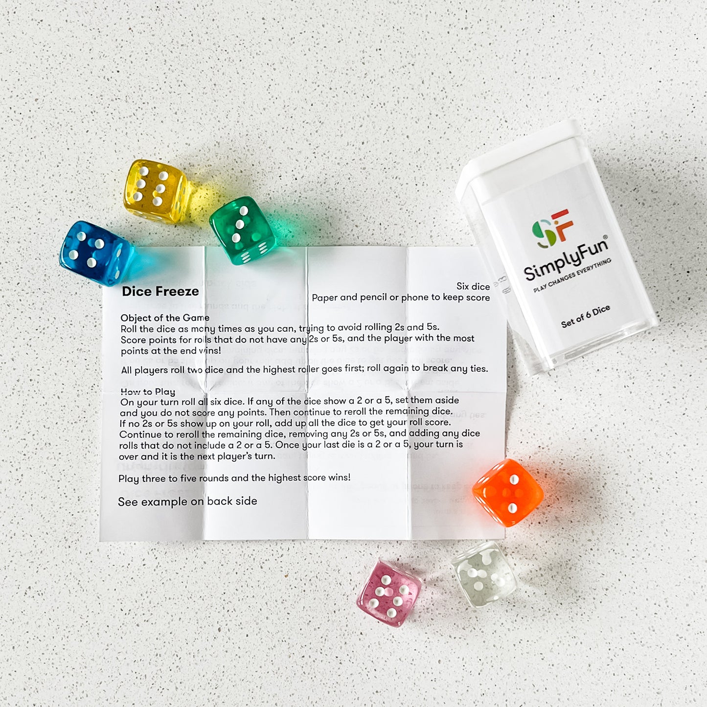 Six colorful dice in a travel box, with a dice game, by SimplyFun.