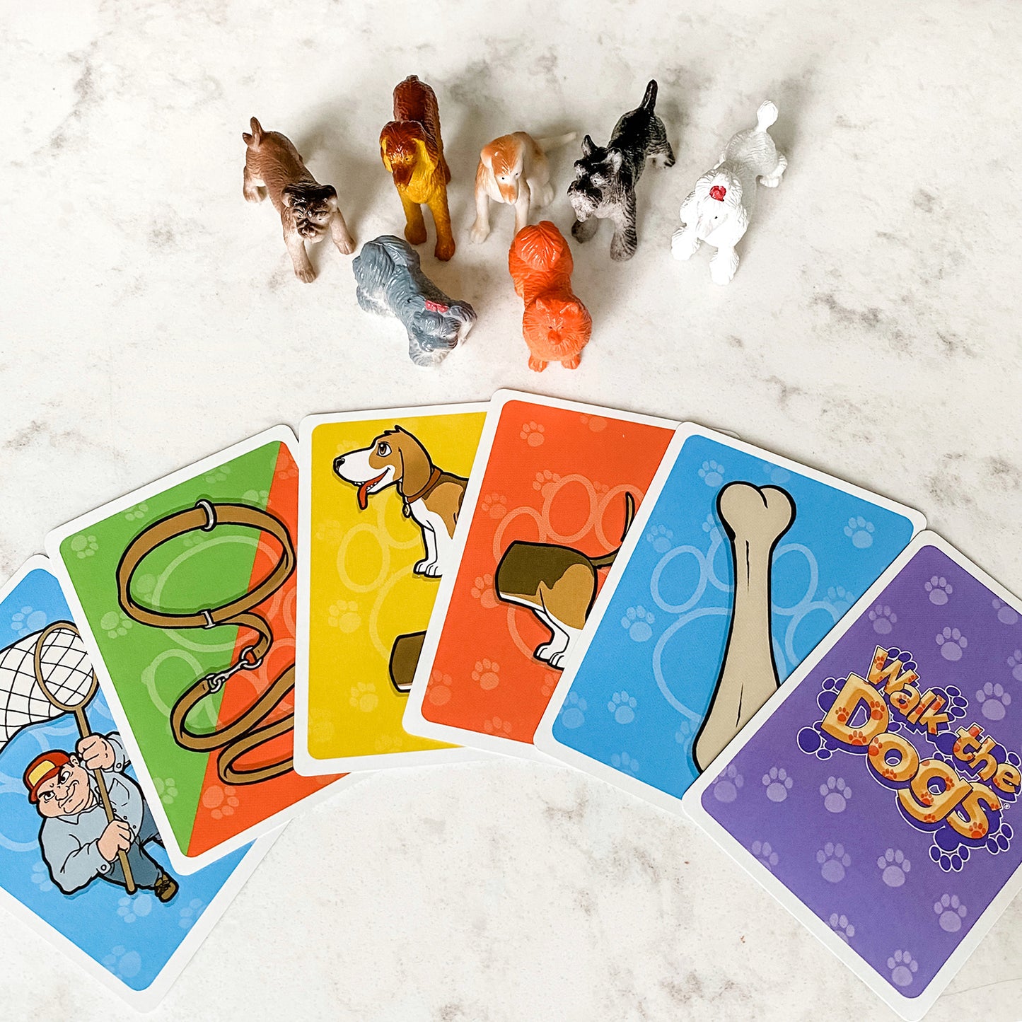 Walk the Dogs by SimplyFun is a math game featuring 63 adorable dogs and focusing on counting and multiplication.